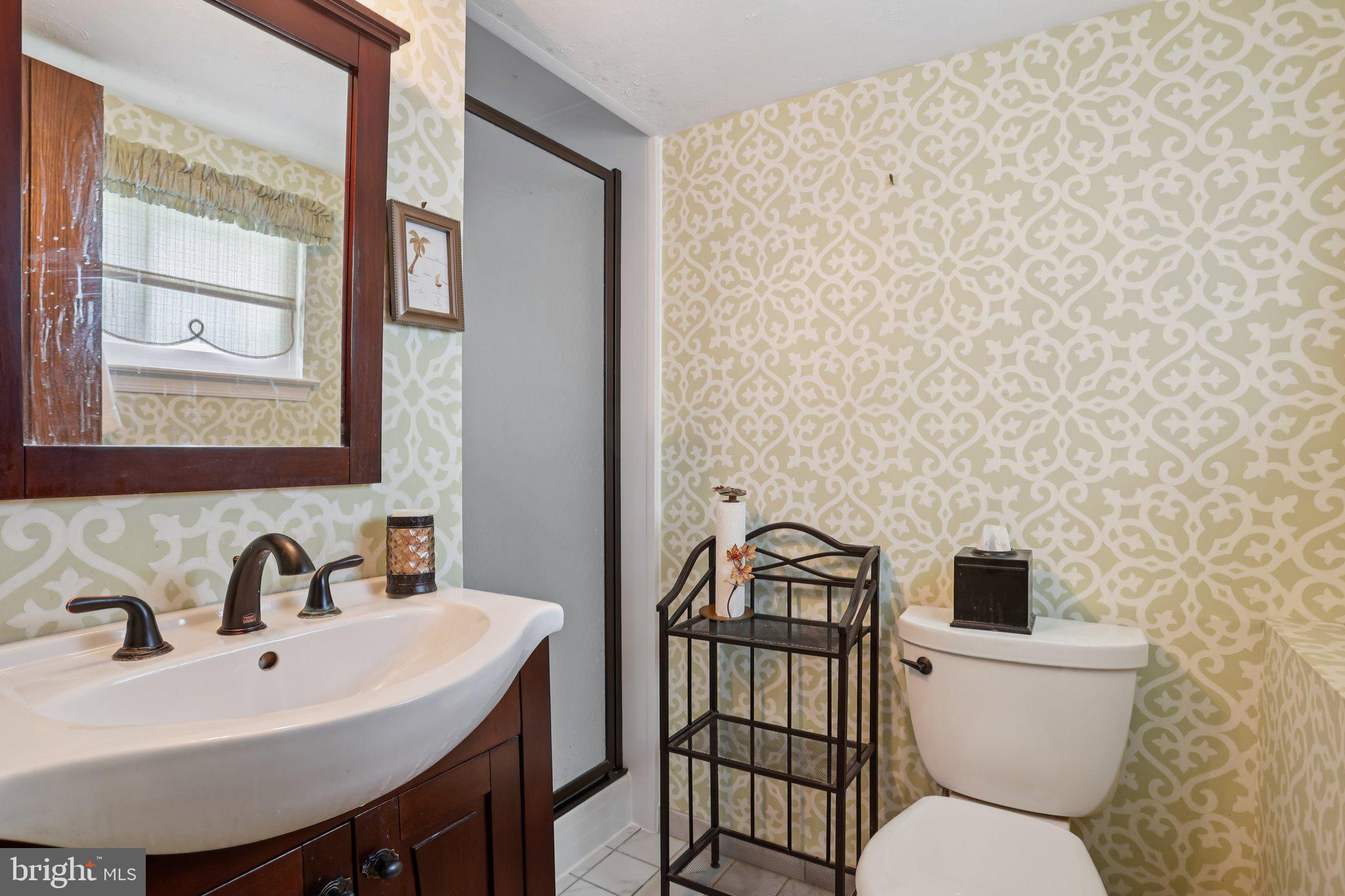 26 Regent Road Cherry Hill, NJ 08003 - Photo 28 of 36 a bathroom with a sink a toilet and a mirror