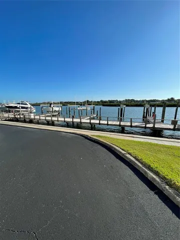 a view of swimming pool with a lawn chairs and ocean view