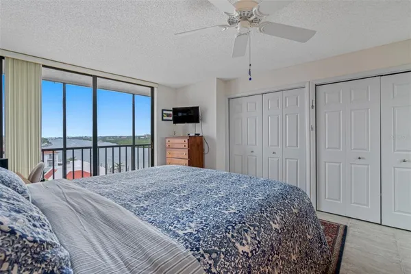 a bedroom with a large bed and a chandelier
