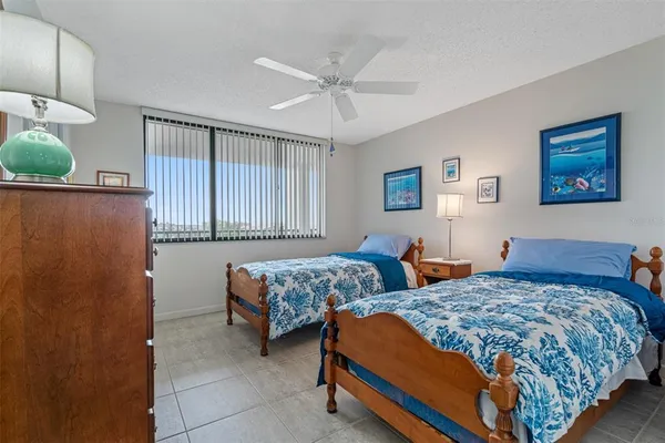 a bedroom with two beds and painting on the wall