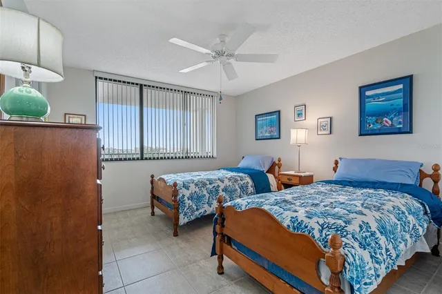 a bedroom with two beds and painting on the wall