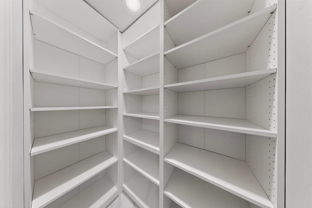 7631 Meadow Road Dallas, TX 75230 - Photo 28 of 40 A bright white pantry filled with neatly organized shelves