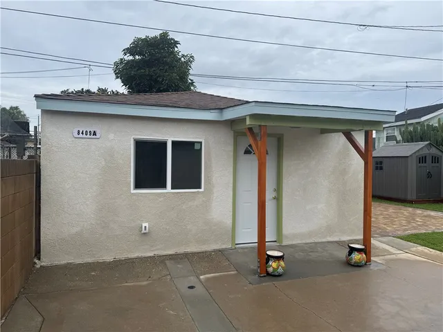 a backyard of a house with table and chairs