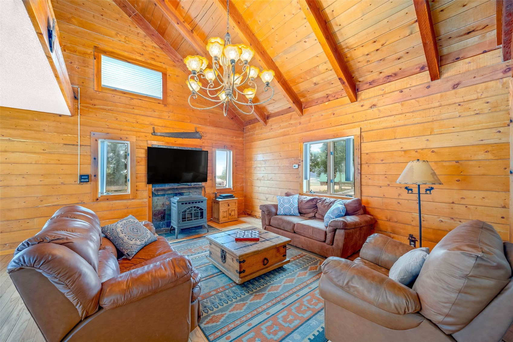 597 Sheep Ridge Road Fairplay, CO 80440 - Photo 4 of 50 a living room with furniture a flat screen tv and a fireplace