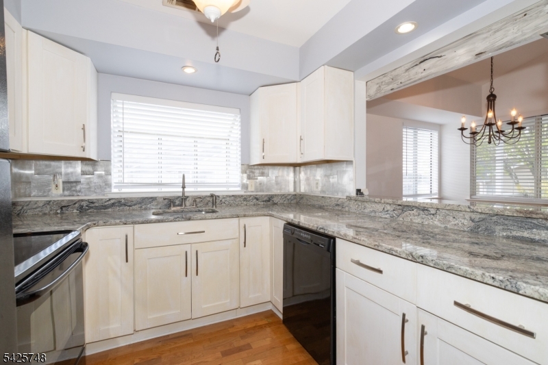 10 Crestmont Road Bedminster, NJ 07921 - Photo 14 of 41 a kitchen with granite countertop white cabinets white appliances and a sink