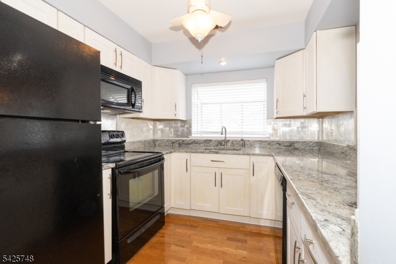 10 Crestmont Road Bedminster, NJ 07921 - Photo 15 of 41 a kitchen with stainless steel appliances granite countertop a sink stove and refrigerator
