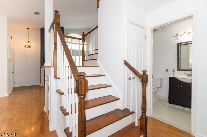 10 Crestmont Road Bedminster, NJ 07921 - Photo 16 of 41 a view of a hallway with wooden floor and staircase