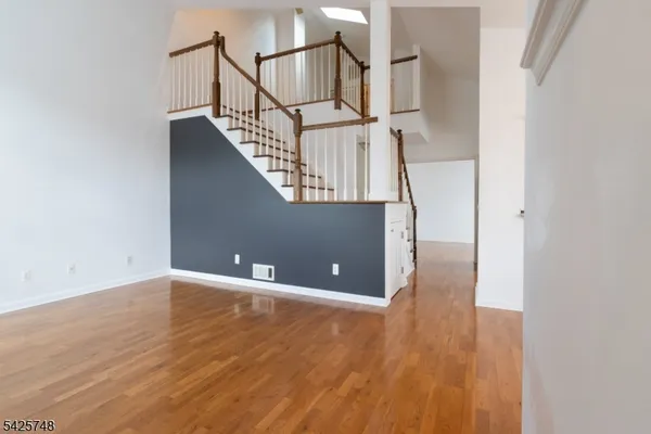 a view of a livingroom with an empty space a fireplace and windows