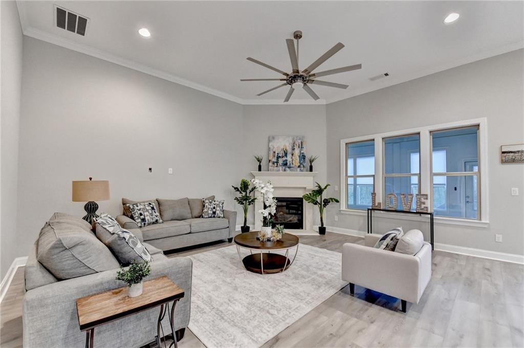 3907 Rustic Pine Lane Buford, GA 30518 - Photo 12 of 70 a living room with furniture and a wooden floor
