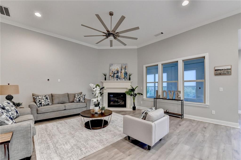 3907 Rustic Pine Lane Buford, GA 30518 - Photo 13 of 70 a living room with furniture a fireplace and a large window