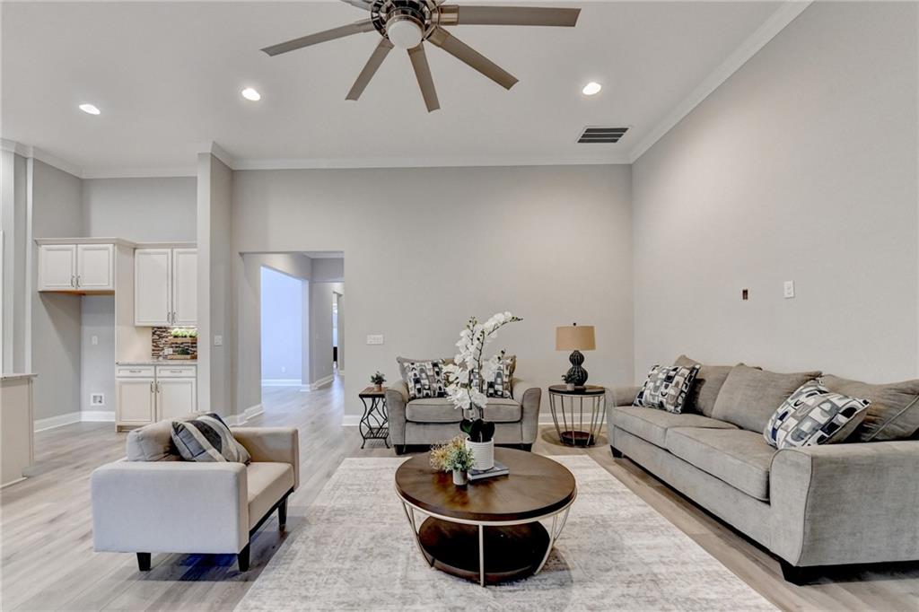3907 Rustic Pine Lane Buford, GA 30518 - Photo 14 of 70 a living room with furniture a rug and a chandelier