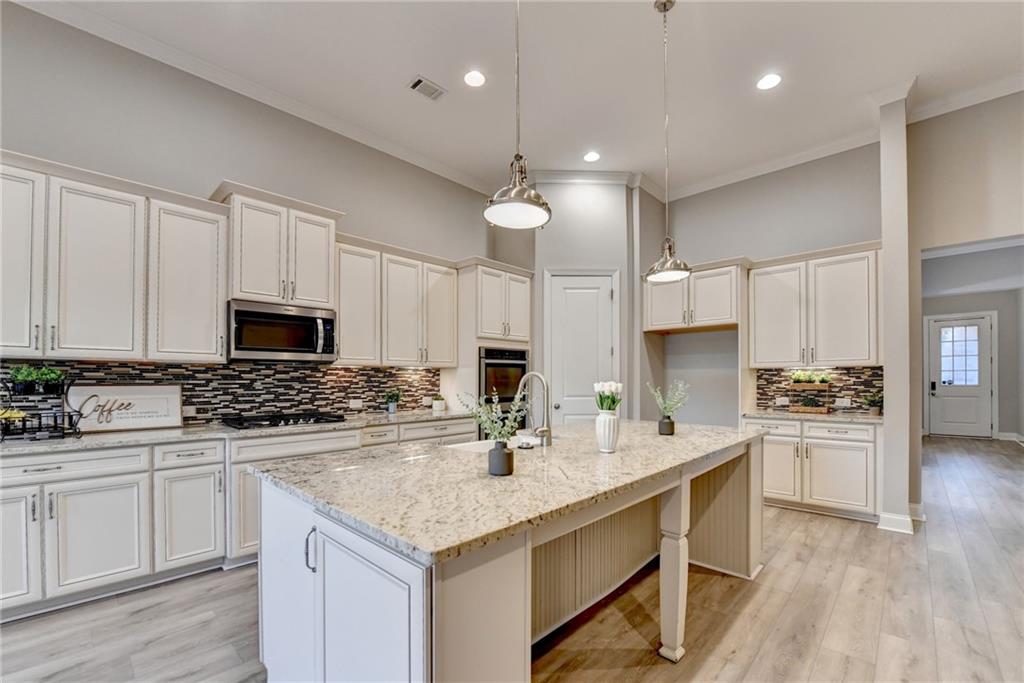 3907 Rustic Pine Lane Buford, GA 30518 - Photo 19 of 70 a kitchen with a sink stove and refrigerator