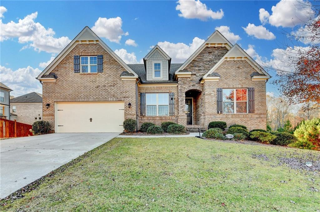 3907 Rustic Pine Lane Buford, GA 30518 - Photo 2 of 70 a front view of a house with a yard