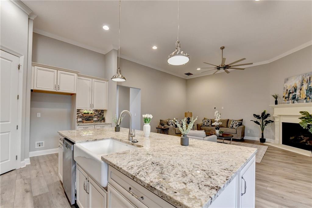 3907 Rustic Pine Lane Buford, GA 30518 - Photo 22 of 70 a kitchen with stainless steel appliances granite countertop a sink stove and refrigerator