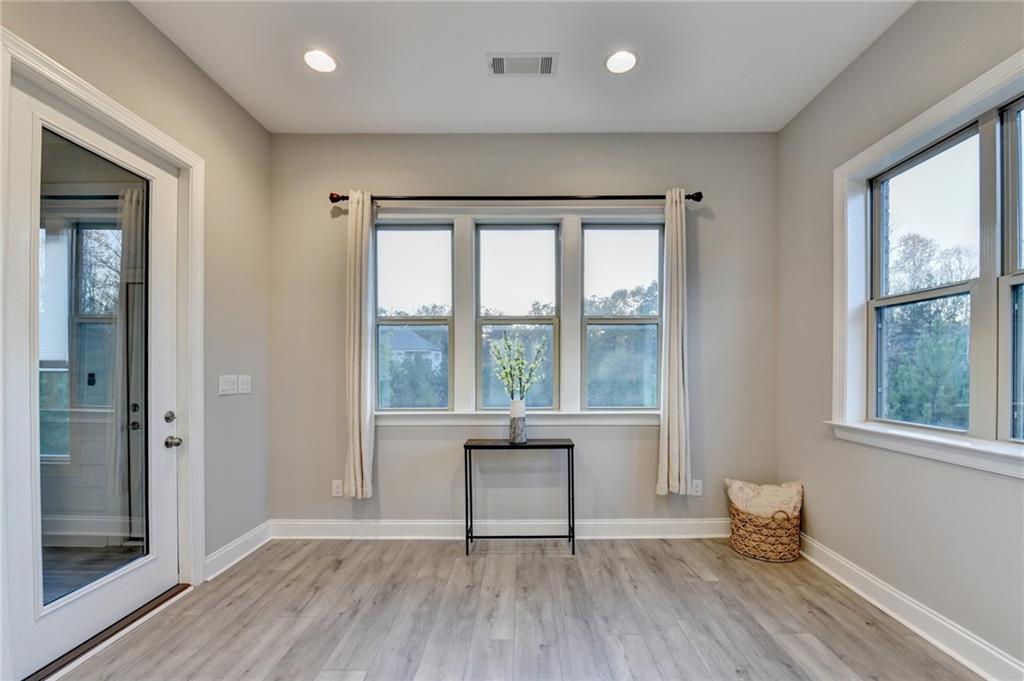 3907 Rustic Pine Lane Buford, GA 30518 - Photo 27 of 70 wooden floor in an empty room with a window