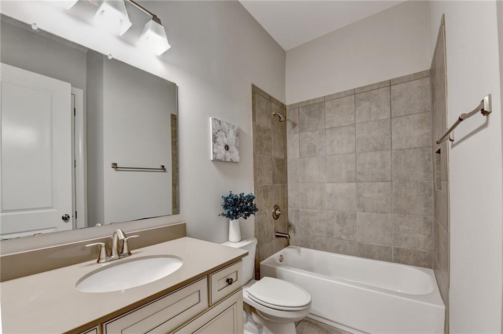 3907 Rustic Pine Lane Buford, GA 30518 - Photo 31 of 70 a bathroom with a granite countertop sink toilet and shower