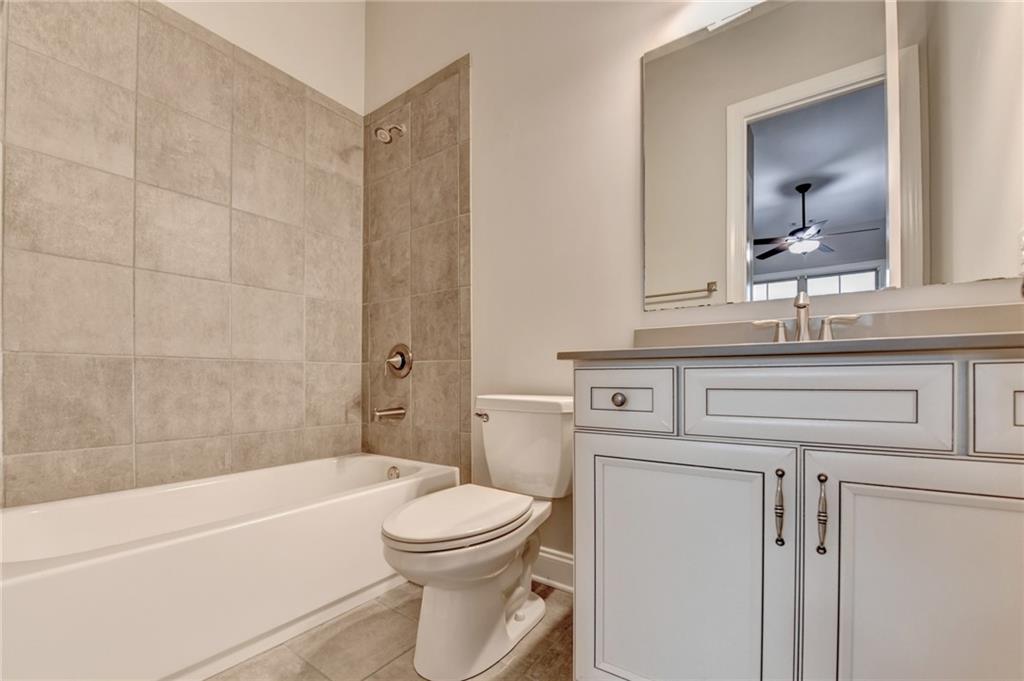 3907 Rustic Pine Lane Buford, GA 30518 - Photo 34 of 70 a bathroom with a sink a toilet and a bathtub