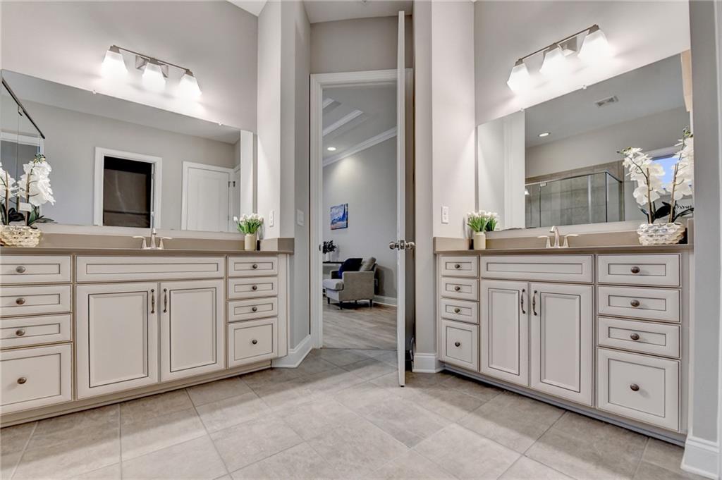 3907 Rustic Pine Lane Buford, GA 30518 - Photo 42 of 70 a spacious bathroom with a double vanity sink and a mirror