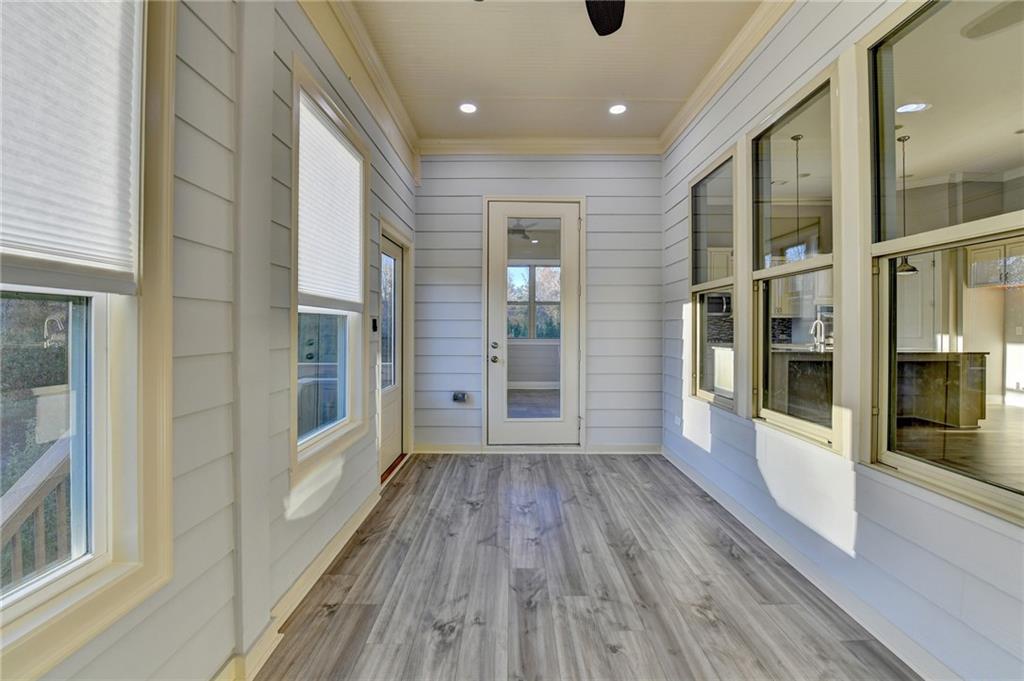 3907 Rustic Pine Lane Buford, GA 30518 - Photo 49 of 70 a view of a hallway with wooden floor and a glass door