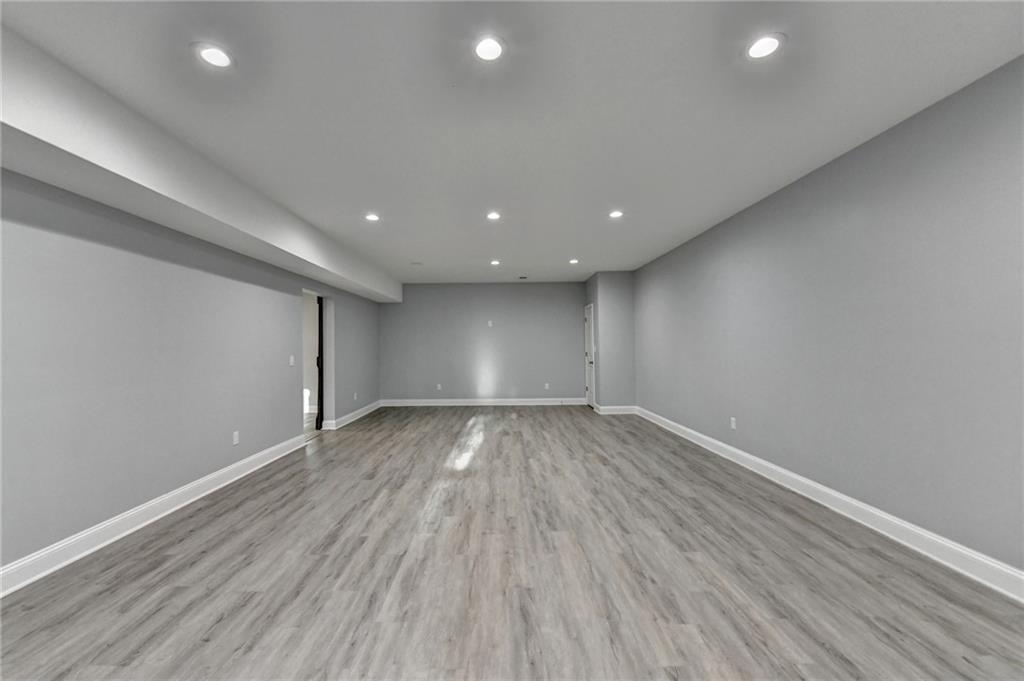 3907 Rustic Pine Lane Buford, GA 30518 - Photo 51 of 70 an empty room with wooden floor and windows