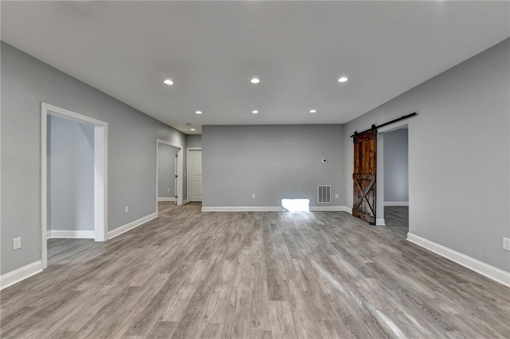 3907 Rustic Pine Lane Buford, GA 30518 - Photo 52 of 70 a view of empty room with wooden floor