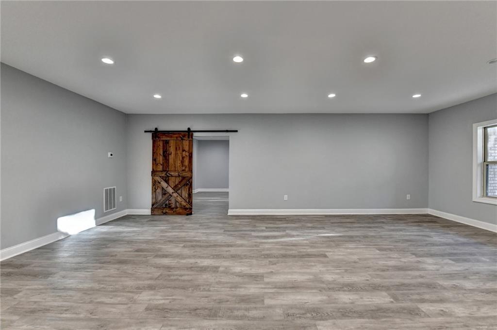 3907 Rustic Pine Lane Buford, GA 30518 - Photo 53 of 70 a view of an empty room with wooden floor