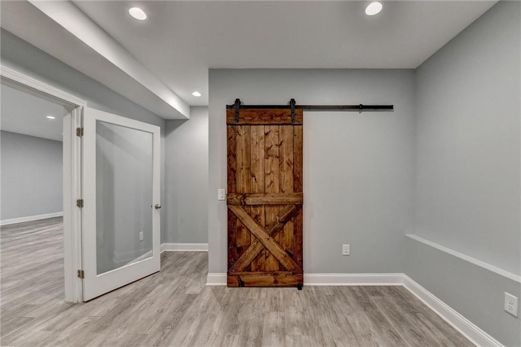 3907 Rustic Pine Lane Buford, GA 30518 - Photo 56 of 70 a view of an empty room with wooden floor