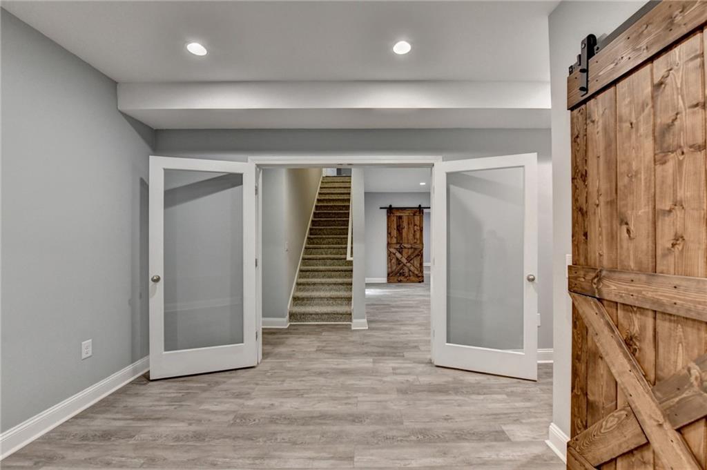 3907 Rustic Pine Lane Buford, GA 30518 - Photo 57 of 70 a view of a hallway with wooden floor and staircase