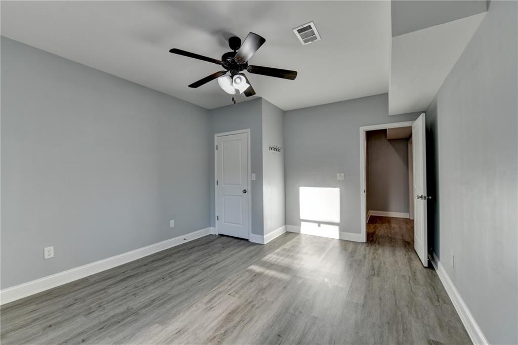 3907 Rustic Pine Lane Buford, GA 30518 - Photo 61 of 70 a view of empty room with wooden floor and ceiling fan