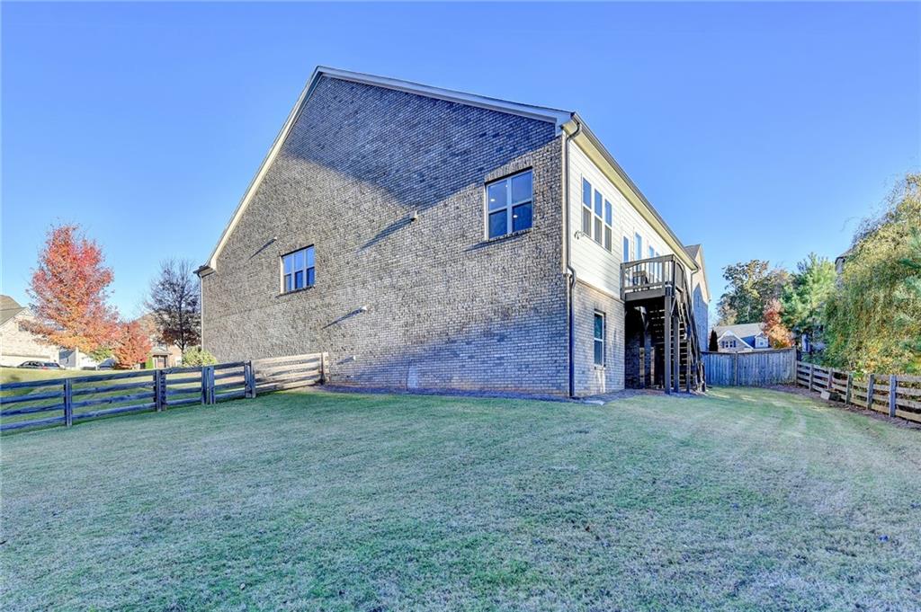 3907 Rustic Pine Lane Buford, GA 30518 - Photo 66 of 70 a view of a house with a yard and sitting area