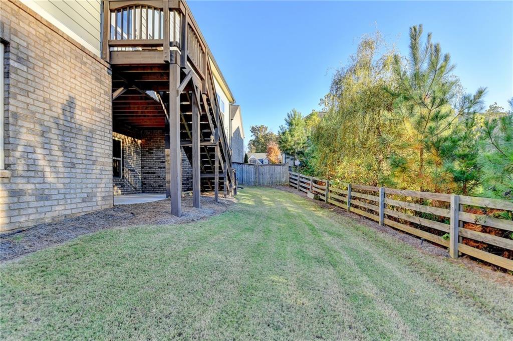 3907 Rustic Pine Lane Buford, GA 30518 - Photo 67 of 70 a view of a house with a yard and wooden fence