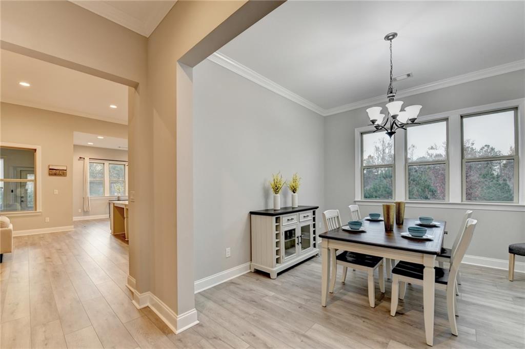 3907 Rustic Pine Lane Buford, GA 30518 - Photo 7 of 70 a view of a dining room with furniture window and wooden floor