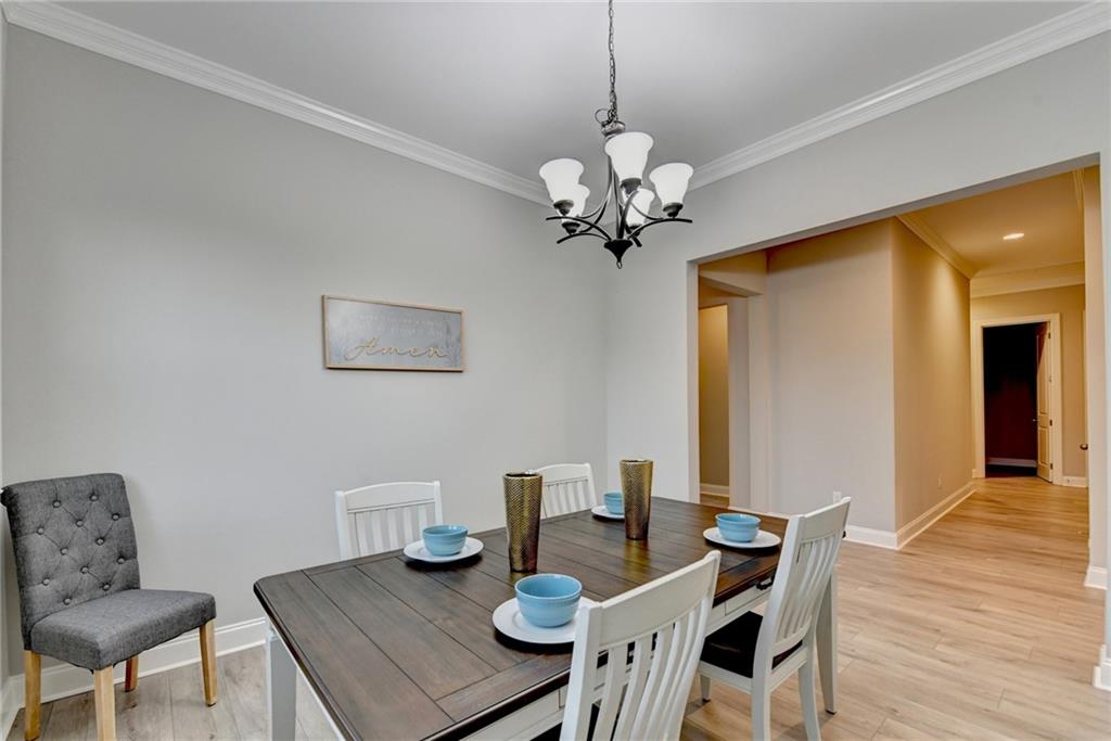 3907 Rustic Pine Lane Buford, GA 30518 - Photo 10 of 70 a view of a dining room with furniture and wooden floor