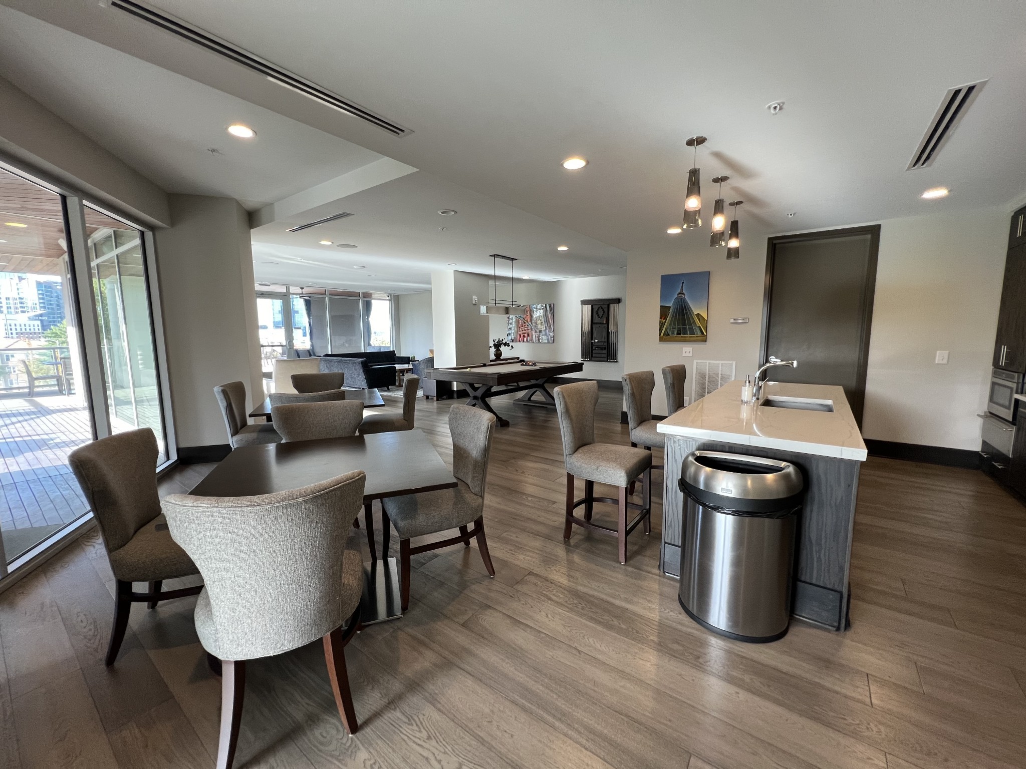 20 Rutledge Street, Unit 704 Nashville, TN 37210 - Photo 11 of 40 a kitchen with stainless steel appliances granite countertop a stove top oven a sink dishwasher a dining table and chairs with wooden floor