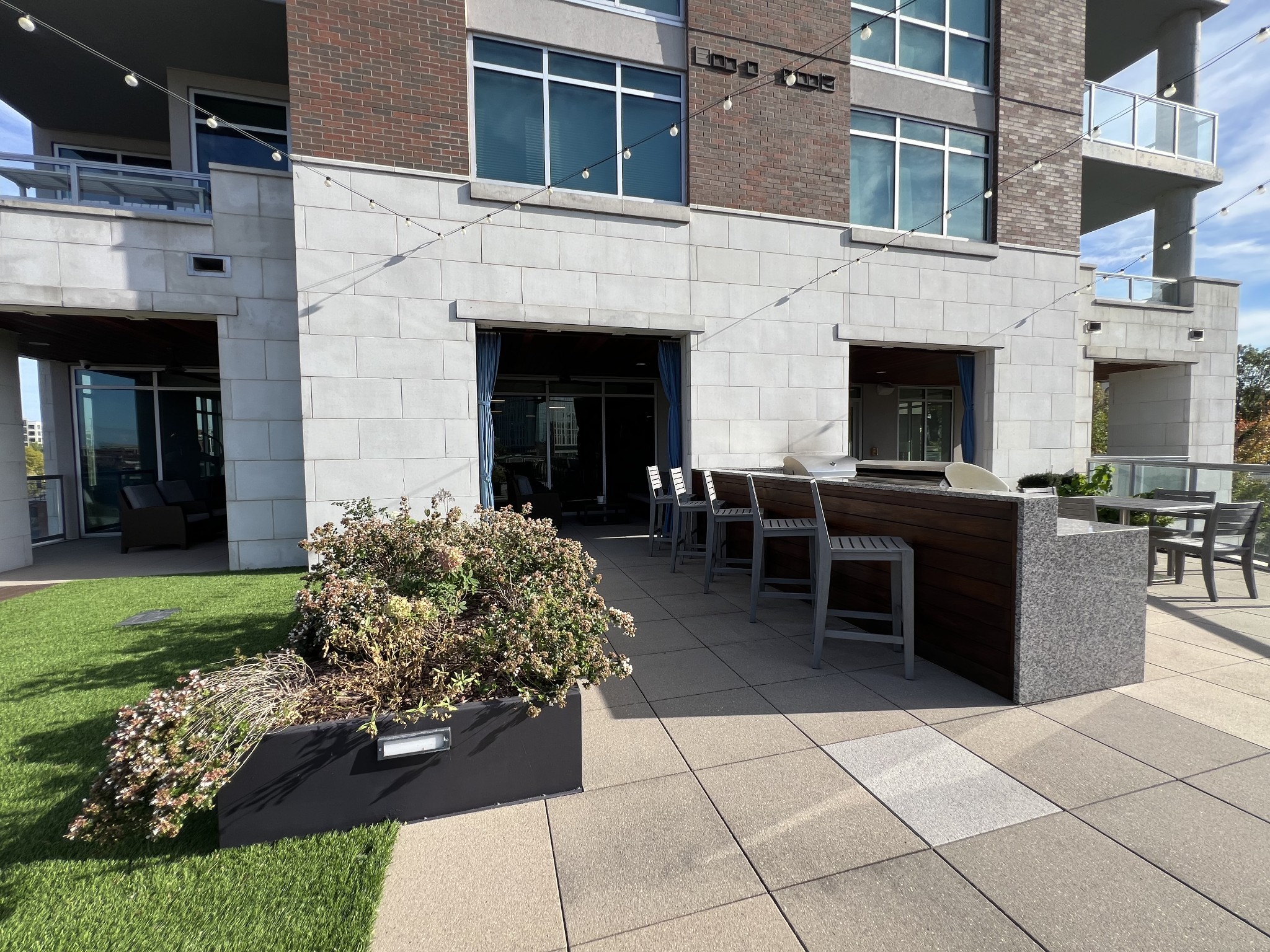 20 Rutledge Street, Unit 704 Nashville, TN 37210 - Photo 17 of 40 a view of a patio with dining table and chairs with plants