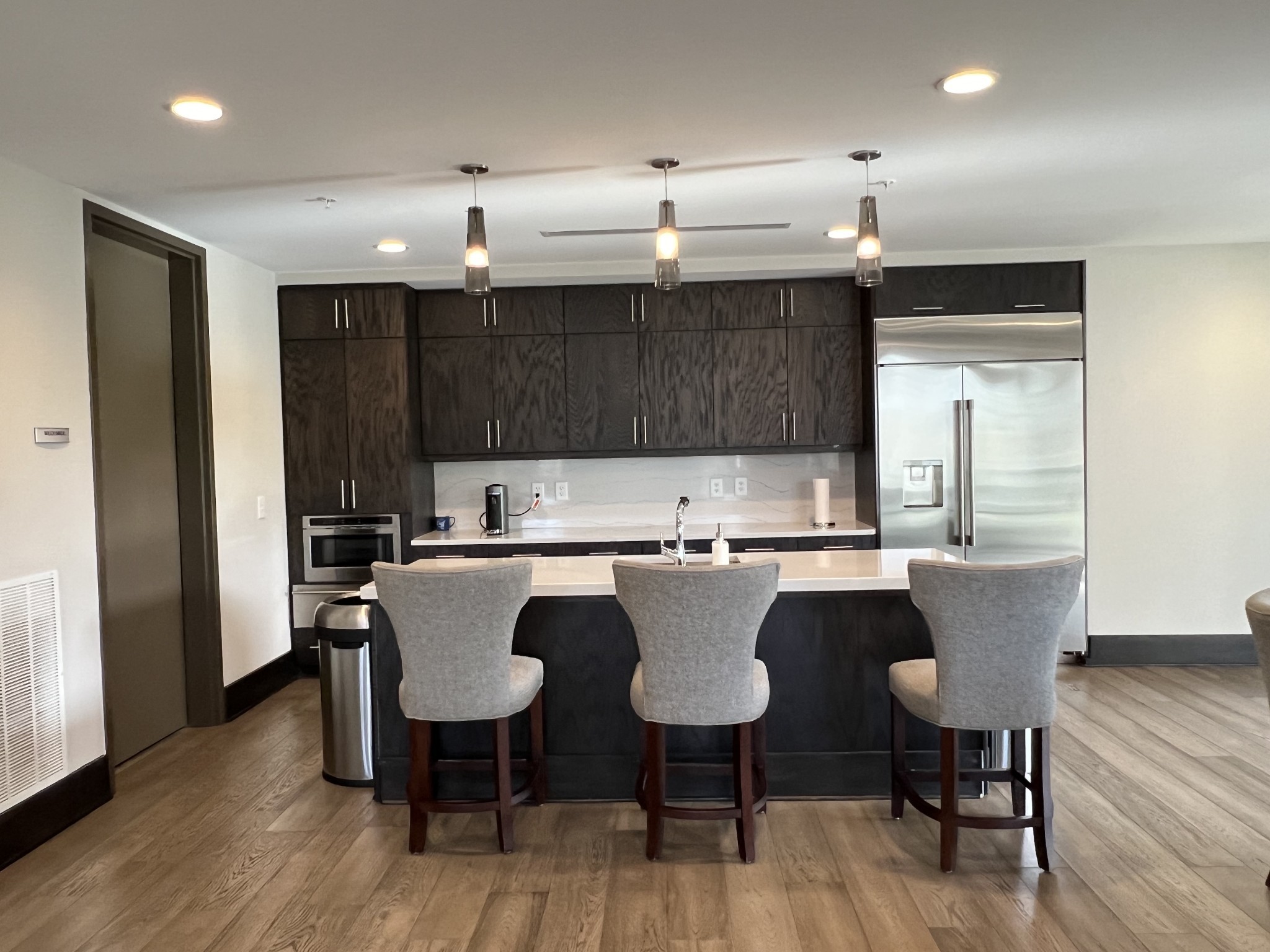 20 Rutledge Street, Unit 704 Nashville, TN 37210 - Photo 9 of 40 a kitchen with a dining table chairs and wooden floor
