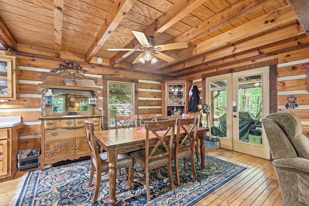 86 Tipton Court Cherry Log, GA 30522 - Photo 75 of 81 a dining room with furniture a rug and wooden floor