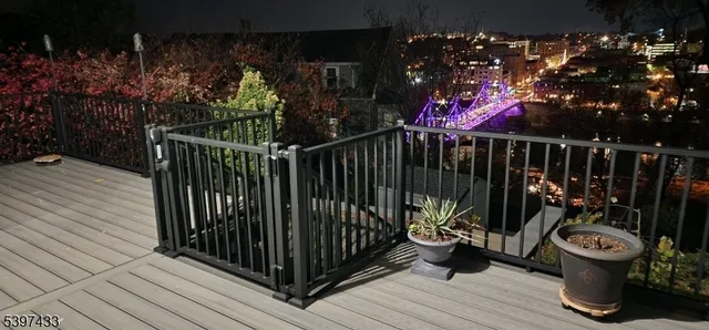 a view of a pathway of a house with wooden deck