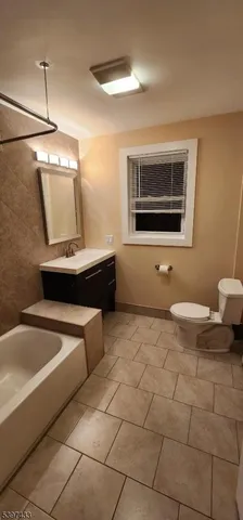 a bathroom with a sink a toilet and bathtub
