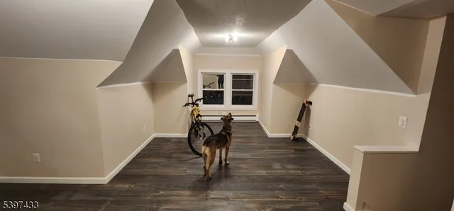 a view of a hallway with wooden floor and stairs
