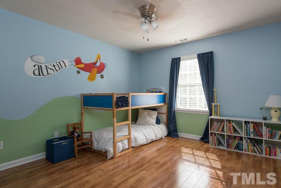 12220 Jarden Court Raleigh, NC 27613 - Photo 11 of 17 a bed room with furniture and a window