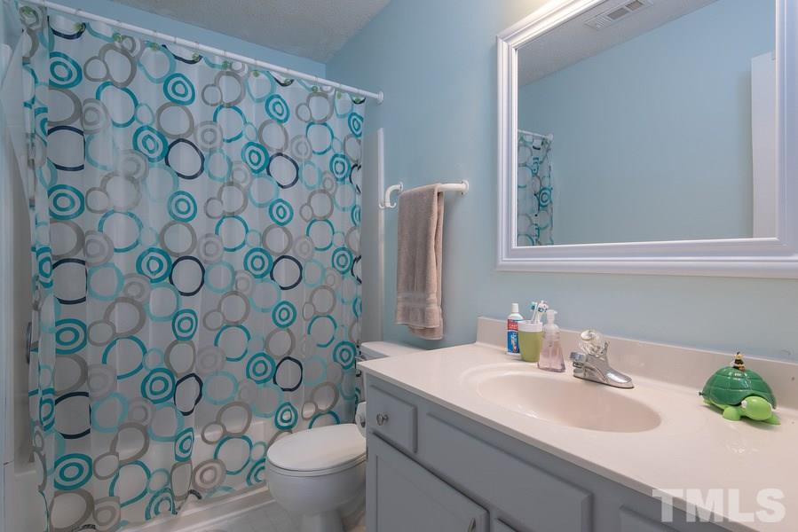 12220 Jarden Court Raleigh, NC 27613 - Photo 12 of 17 a bathroom with a sink and a mirror