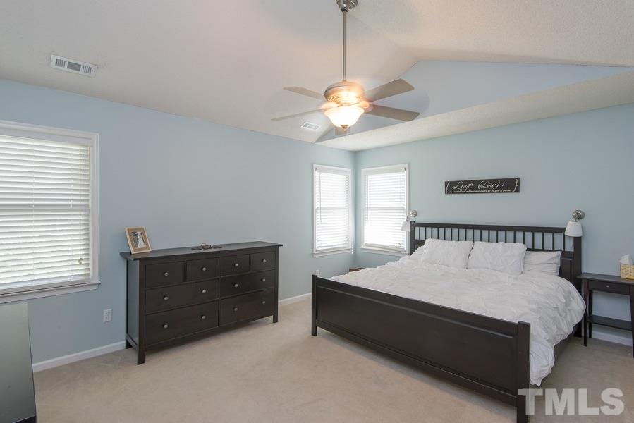 12220 Jarden Court Raleigh, NC 27613 - Photo 13 of 17 a bedroom with a bed and window
