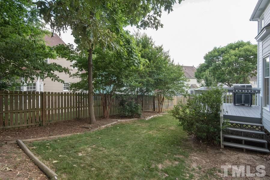 12220 Jarden Court Raleigh, NC 27613 - Photo 17 of 17 a garden view with tall trees