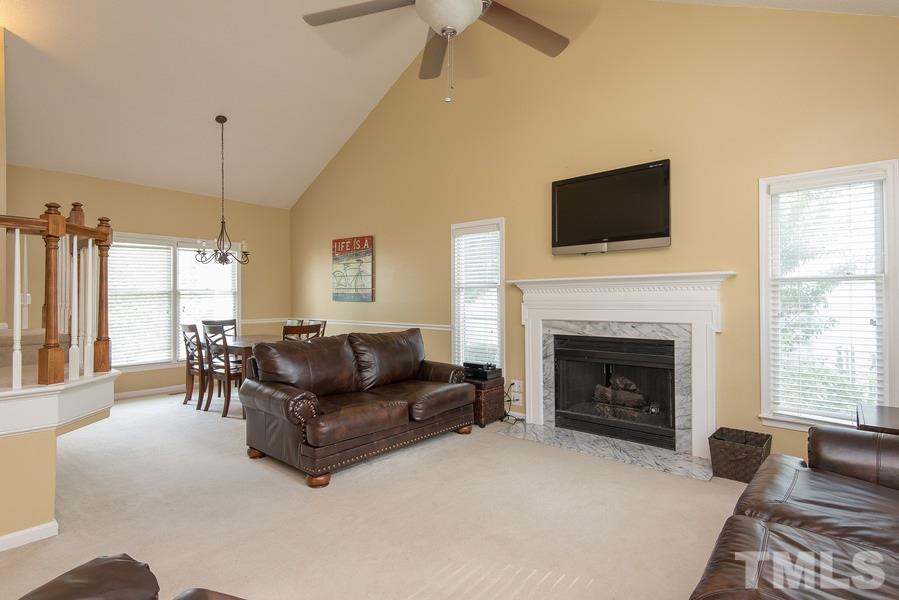 12220 Jarden Court Raleigh, NC 27613 - Photo 4 of 17 a living room with furniture fireplace and flat screen tv