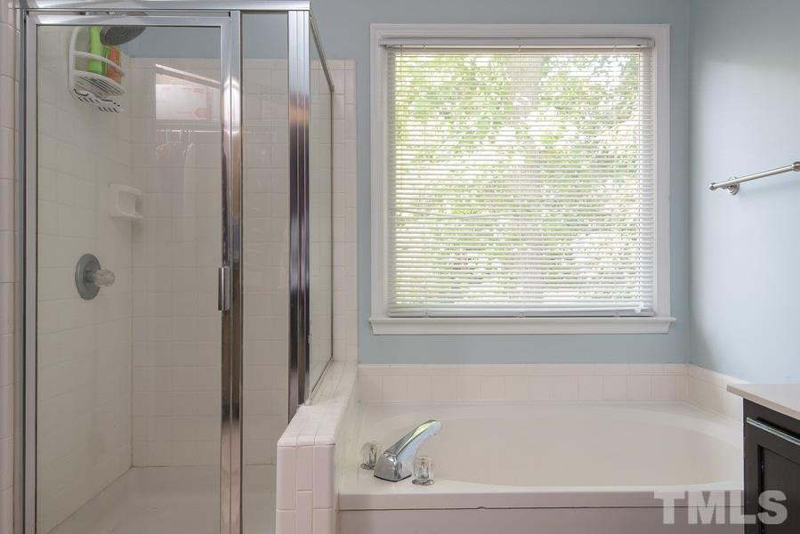 12220 Jarden Court Raleigh, NC 27613 - Photo 10 of 17 a bathroom with a bathtub and a shower