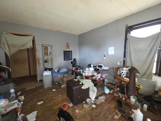 a living room with lots of furniture and a wooden floor
