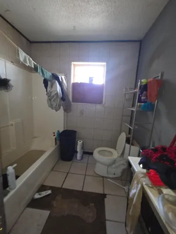 a bathroom with a toilet and shower