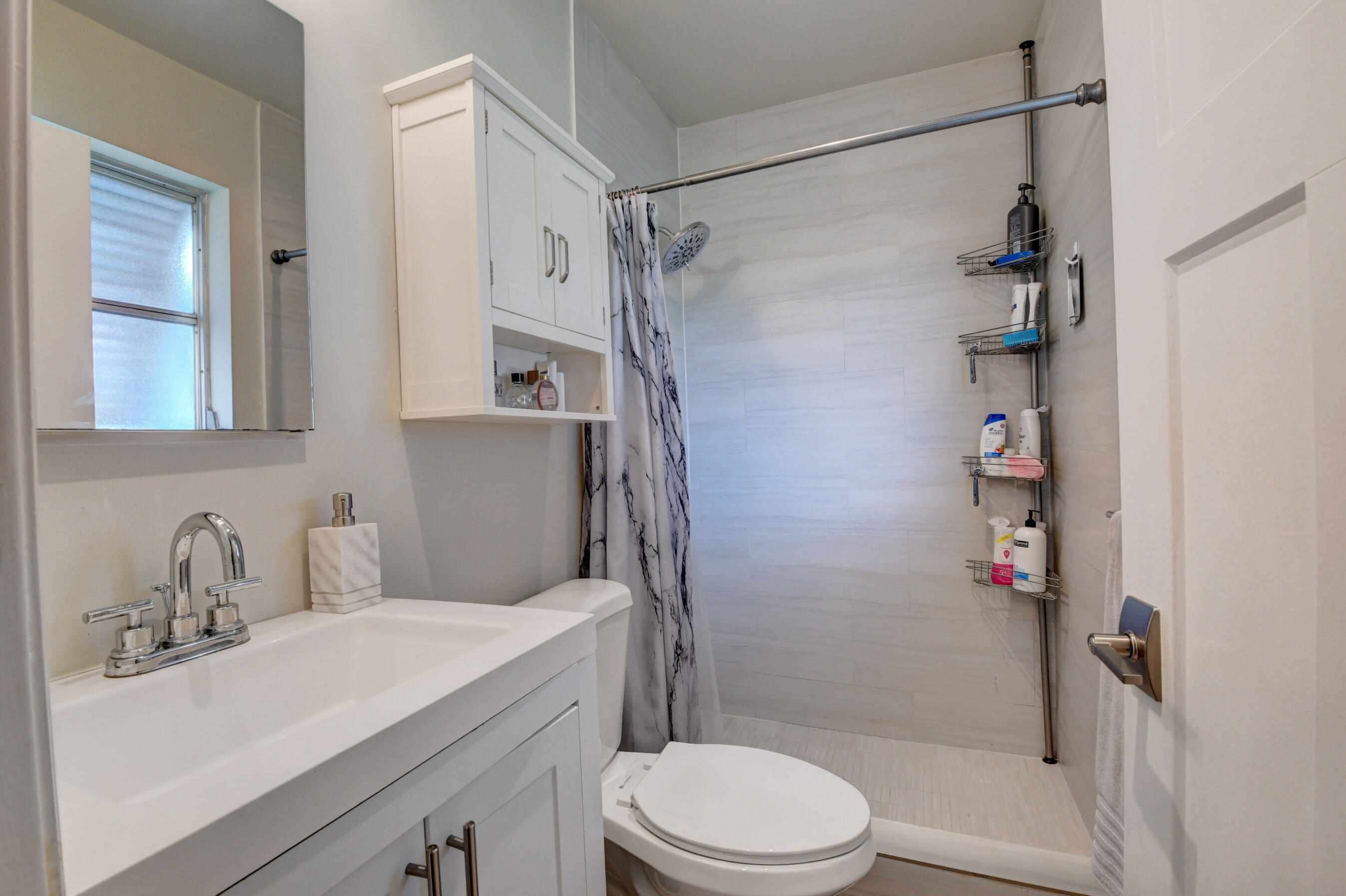 956 Southwest 4th Street Boca Raton, FL 33486 - Photo 28 of 52 a bathroom with a sink toilet and shower