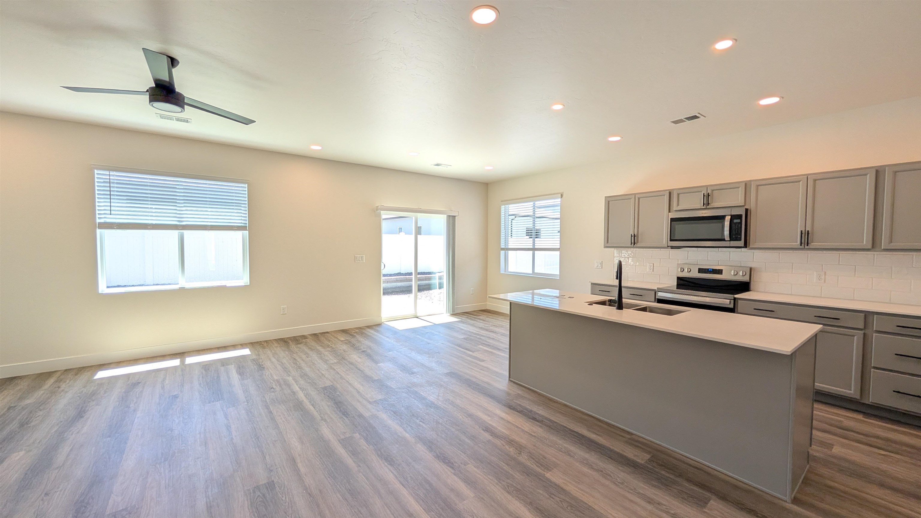 1660 Rusty Rivet Road Fruita, CO 81521 - Photo 4 of 15 a kitchen with stainless steel appliances a microwave a stove a sink dishwasher and a microwave oven on the wooden floor